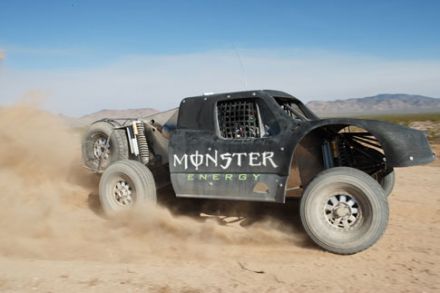 Monster Energy Trophy Truck kicking up dirt in the Baja 1000