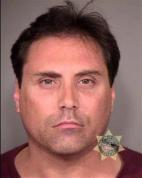 Police in Portland, Ore., have arrested a man who is suspected of making harassing phone calls and sending upsetting e-mails to the families of those killed in the Aurora theater shooting.