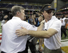 Colorado coach Mike MacIntyre, left, and Oklahoma State coach Mike Gundy, right, meet at midfield following the Alamo Bowl NCAA college football game, Thursday, Dec. 29, 2016, in San Antonio. Oklahoma State won 38-8. (AP Photo/Eric Gay)