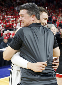 Eaglecrest Head Coach and senior Colbey Ross embrace after what will be their final game for Eaglecrest after winning the 5A State Championship game, March 11 at the Denver Coliseum. Eaglecrest overcame a six-point deficit at the end of the first half defeating George Washington 53-47. (Photo by Philip B. Poston/Aurora Sentinel)
