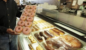 FILE - In this April 26, 2011 file photo, doughnuts are displayed in Chicago. There are a lot fewer trans fats in the nations food than there were a decade ago, but the Obama administration is moving toward getting rid of them almost entirely. The Food and Drug Administration says Americans still eat about a gram of trans fat every day, and phasing it out could prevent 20,000 heart attacks and 7,000 deaths each year. (AP Photo/M. Spencer Green, File)