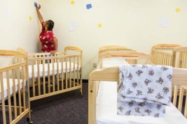 A nursery worker at APS Early Beginnings program gets the school nursery ready for the day. The program for teen mothers works to help young moms get their diploma and avoid the known pitfalls of teen parents. A state program that allows for free birth control could be in jeopardy because of Republican opposition. The program is credited with reducing teen pregnancy and the need for programs like the one in APS.