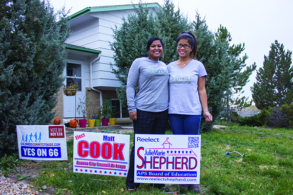 Julie Marie Shepherd (left), school board candidate, and her sister Sarah plant signs in hopes of gathering more votes, Oct. 29 in Aurora. Candidates for this election also include Jasper Armstrong and Amber Drevon.(Danielle Shriver/ Aurora Sentinel)