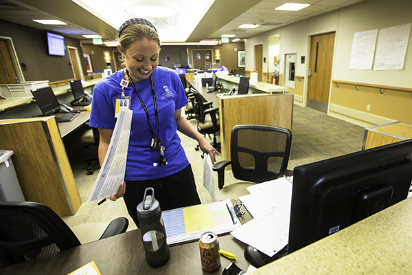 RN Kyle Hammond shuffles through paperwork, June 17 at the University of Colorado Hospital. The new 12-story, 734,00-square-foot inpatient tower is part of a $400-million-expansion project and gives the hospital 144 more patient beds. (Marla R. Keown/Aurora Sentinel)