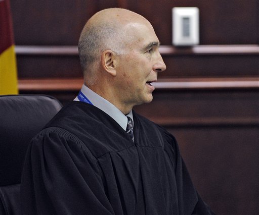 District Court Judge William Blair Sylvester speaks as James E. Holmes appears in Arapahoe County District Court. On Tuesday, Sylvester refused to lift a gag order in the Holmes Aurora theater shooting case, despite days of testimony and revelations during a public hearing in January.)
