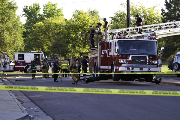 Members of the bomb squad and fire department come down a ladder after assessing shooting suspect James Holmes' apartment Friday morning, July 20, at Paris Street and East 17th Avenue. Aurora will hire a consultant to analyze police and fire response to the shooting and attempted bombing that killed 12 inside Century 16 Theater and wounded about 70 others. (Marla R. Keown/Aurora Sentinel)
