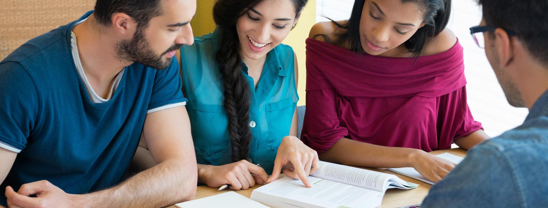 group of students looking at a book