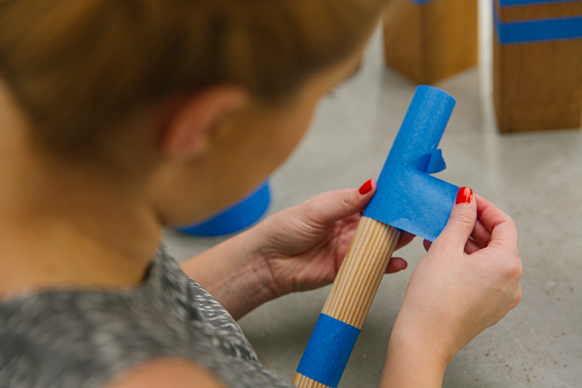 Masking DIY Kubb yard game baton with painters' tape.