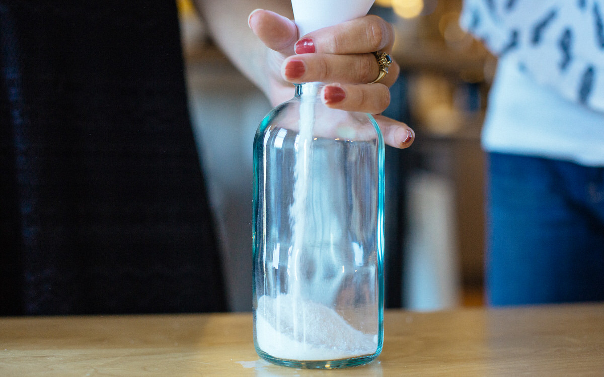 pouring homemade dishwasher detergent