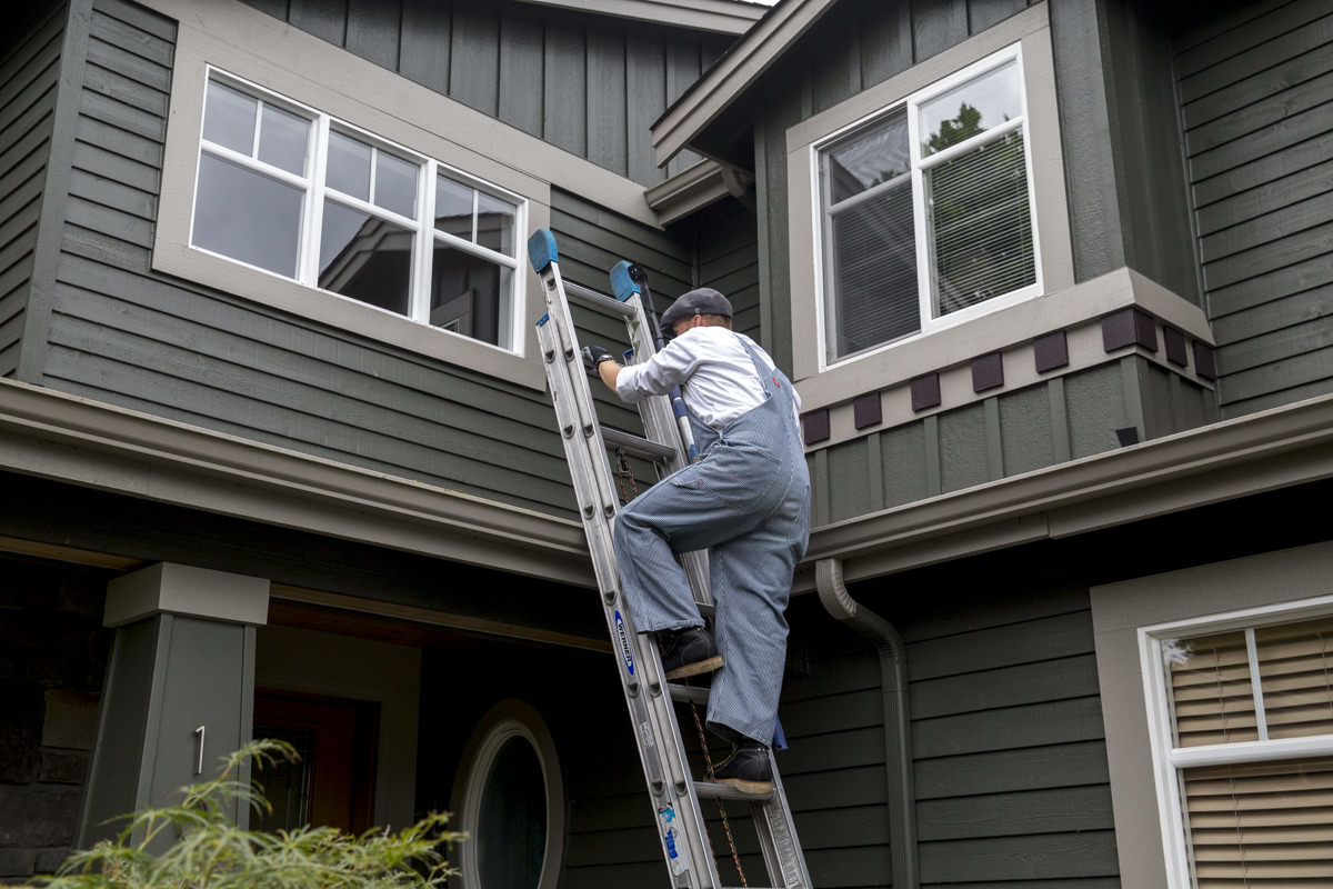 climbing ladder onto house