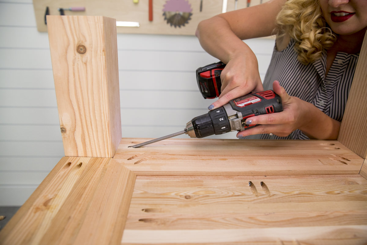 driving screws into nightstand shelf