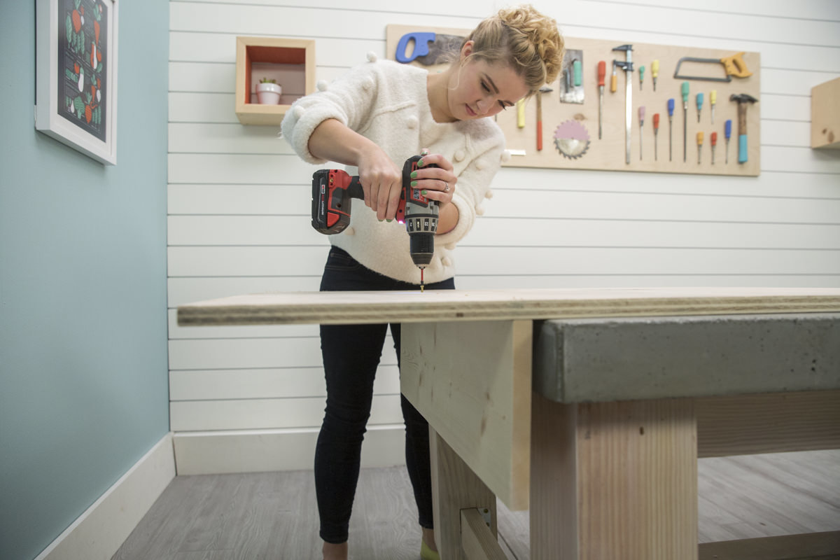 drilling holes for shelf in storage pegboard