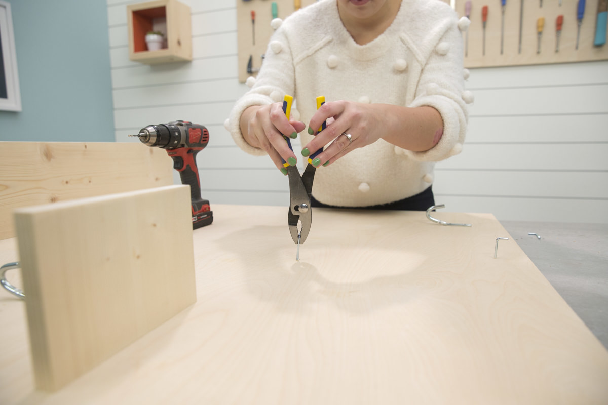 attaching small hooks on storage pegboard