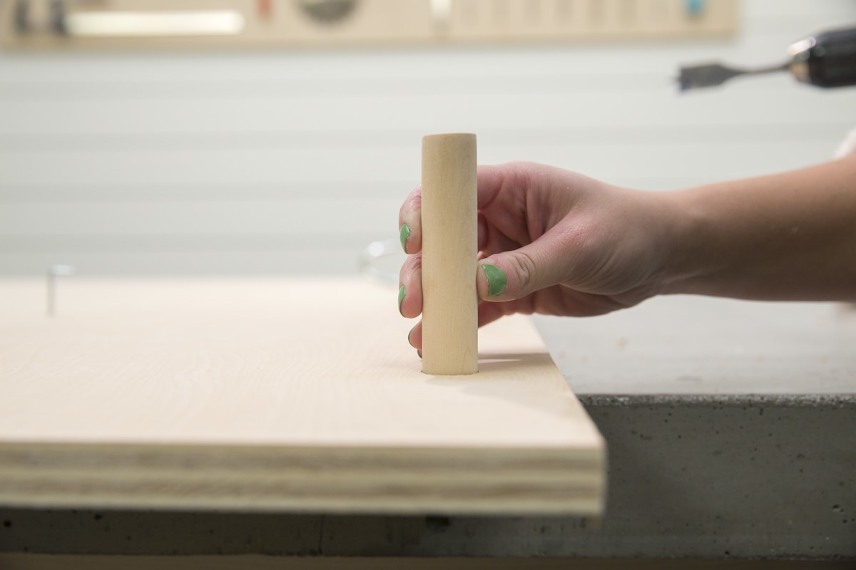 inserting peg into storage pegboard