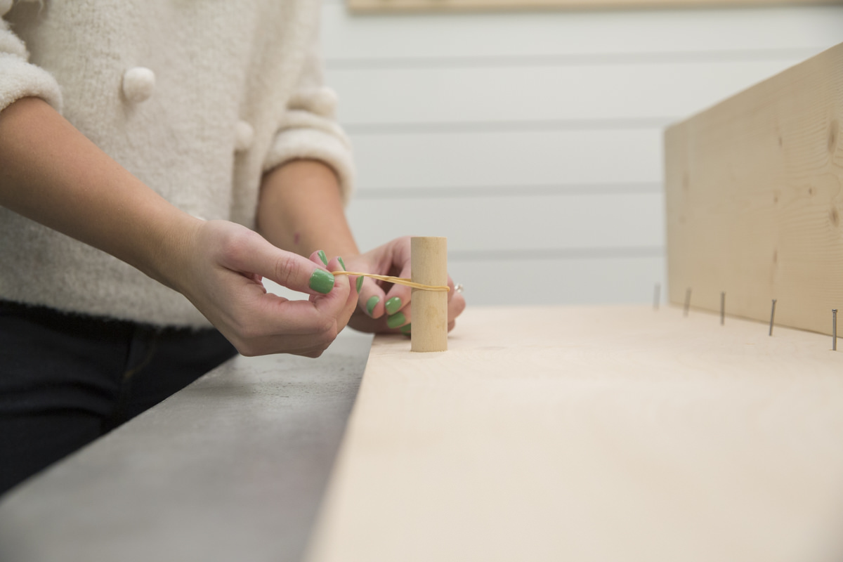 rubber band on dowel gaps for storage pegboard