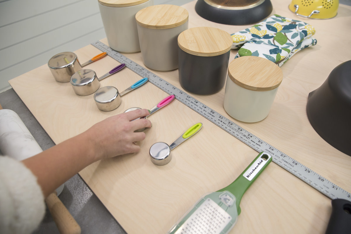 arranging measuring cups for storage pegboard