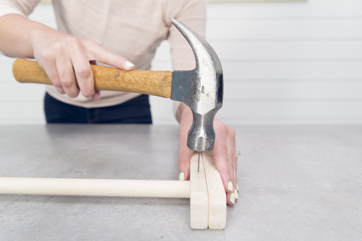 hammering nail on wooden leg