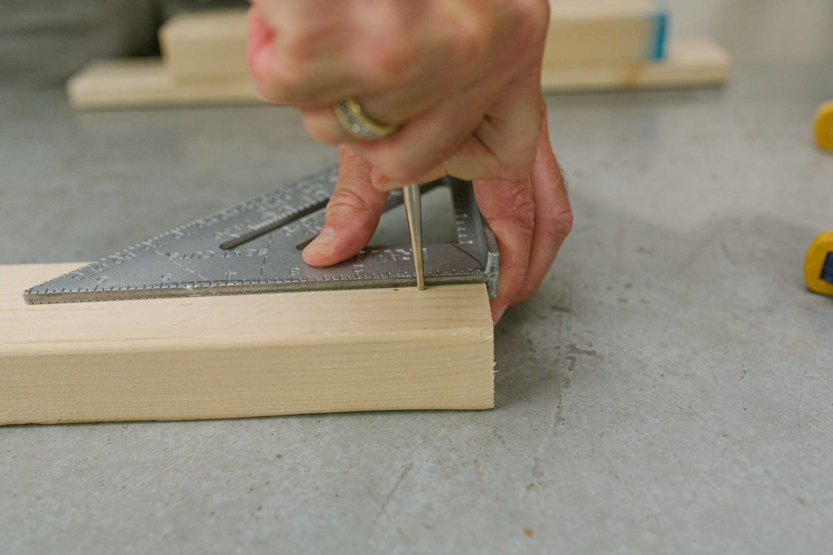 Marking board with speed square and awl.