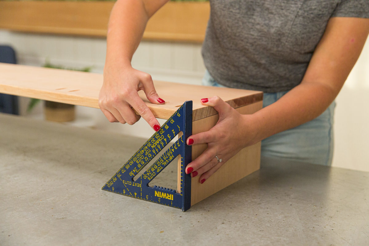 Lining up doug fir boards at right angle with speed square.