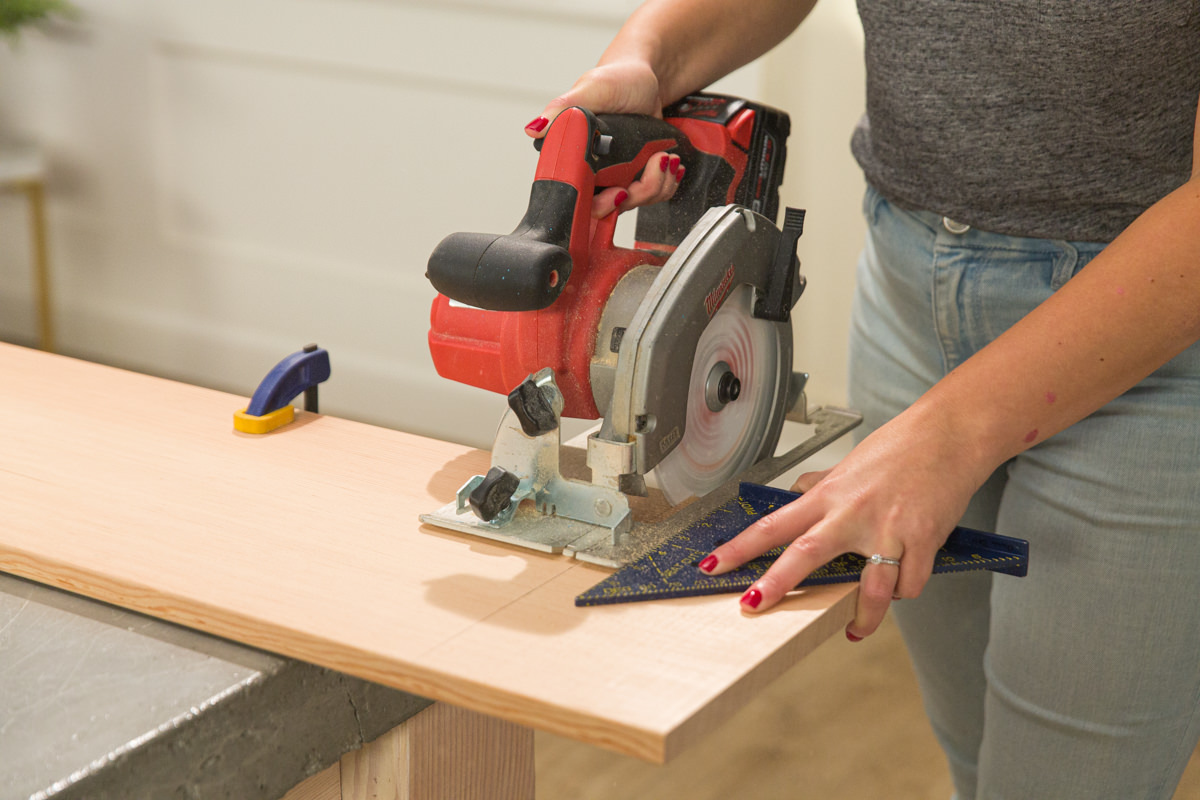 Cutting clamped doug fir board with circular saw and speed square.