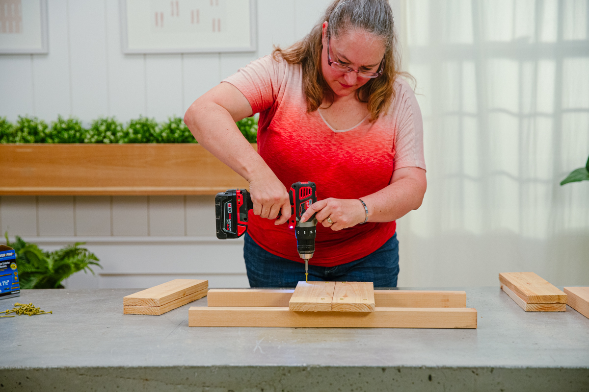 Driving screw to attach center boards to posts.