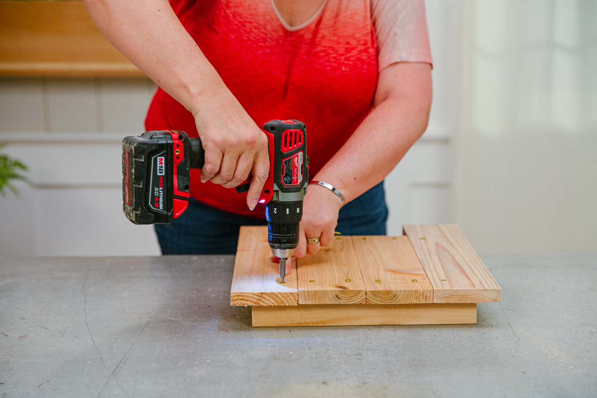 Driving screw to attach a side board to posts.