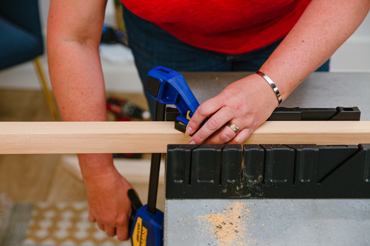 Clamping board in miter box.