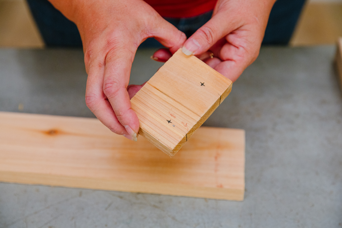 Jig made with piece of 1x4 scrap wood, with x marked .75" from each side and from the end. 