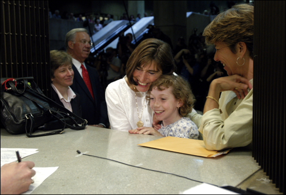 Julie and Hillary Goodridge, named plaintiffs in the Massachuestts victory, at last marry with their daughter and attorney Mary Bonauto looking on.