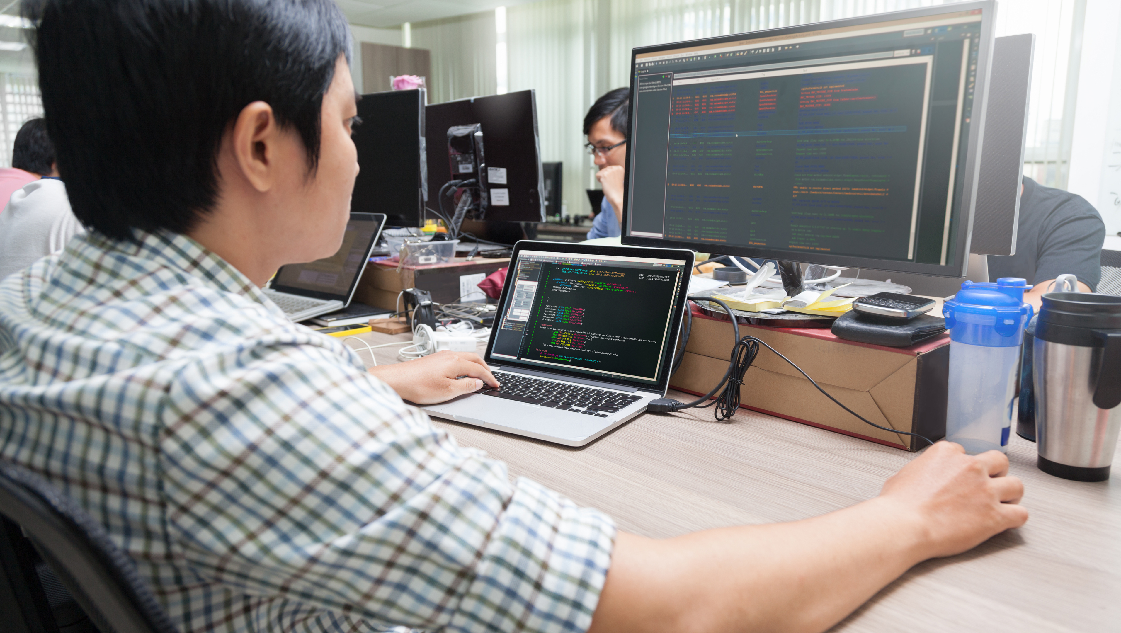 A System Administrator monitors the network from a computer screen.