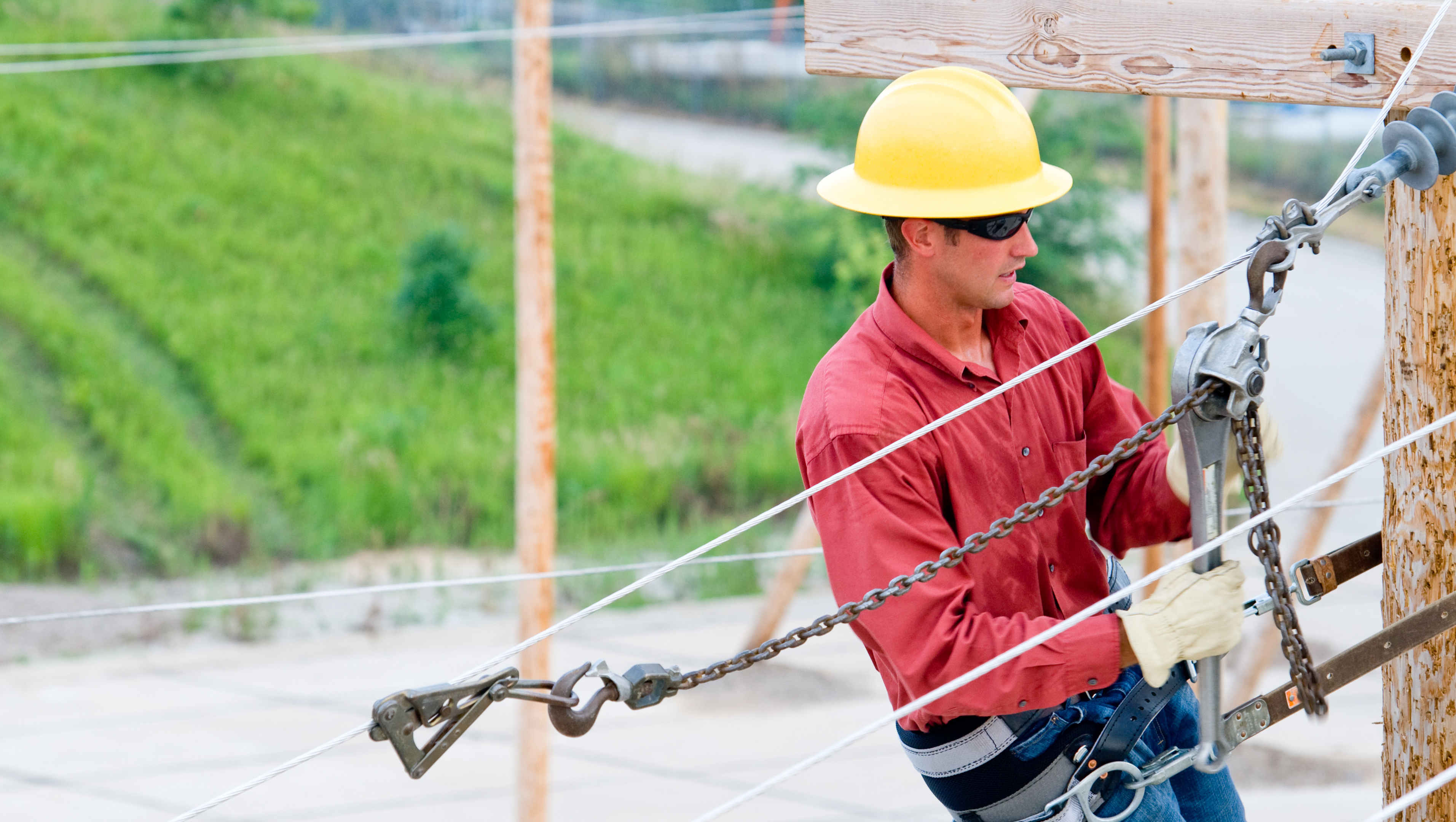 An overhead line construction worker works on an electrical line.