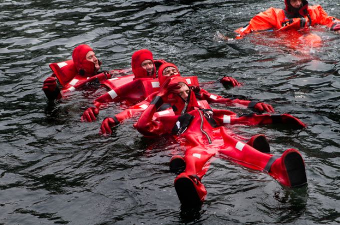 deadliest jobIn a formation called "the worm," crewmen link up to be able to paddle against strong waves and winds to a lifeboat. (Photo by Jesse Costa/WBUR) In a formation called "the worm," crewmen link up to be able to paddle against strong waves and winds to a lifeboat. (Photo by Jesse Costa/WBUR)