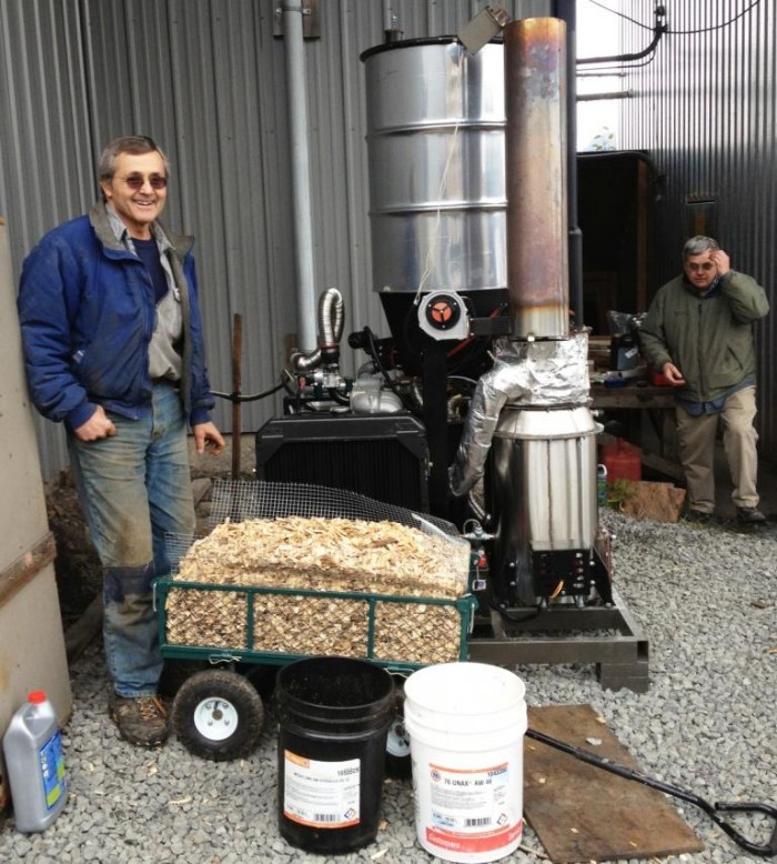 10-18-12 wood gasifier at icy straits photo 2 - Sealaska compressed Wes Tyler, left, stands by a new wood gasifier at Icy Straits Lumber in Hoonah. John Hillman of the Hoonah Indian Association is on the right