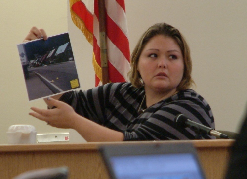 Haley Tokuoka holds up a picture of Hoonah's Front Street during John N. Marvin, Jr.'s trial in Oct. 2012. (Photo by Matt Miller/KTOO)
