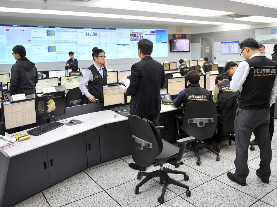 South Korea is looking for the source of cyberattacks that took down networks this week. Members of the Korea Internet Security Agency check on cyberattacks at a briefing room Wednesday. Jung Yeon-Je/AFP/Getty Images