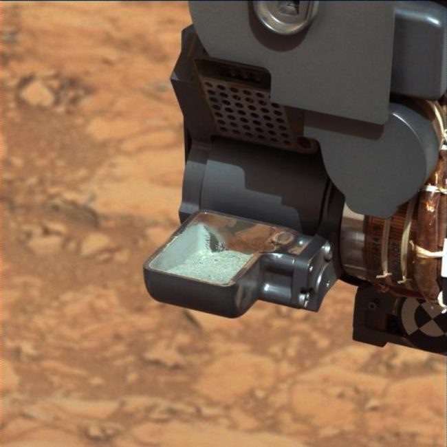 mars-rover This image from NASA's Curiosity rover shows the first sample of powdered rock extracted by the rover's drill. NASA/JPL-Caltech/MSSS