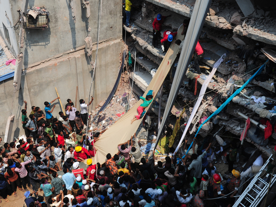 Volunteers on Thursday use a length of textile as a slide to move victims from the rubble of a collapsed building in Savar, Bangladesh. AFP/Getty Images Volunteers on Thursday use a length of textile as a slide to move victims from the rubble of a collapsed building in Savar, Bangladesh. AFP/Getty Images