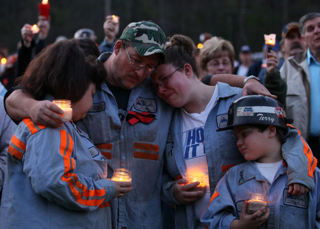In this 2010 photo, coal miner Terry Cooper, left, embraces his wife Michelle, daughter Tera and son Justin, during a vigil to honor the coal miners that were killed in Montocal, West Virginia. Mark Wilson/Getty Images In this 2010 photo, coal miner Terry Cooper, left, embraces his wife Michelle, daughter Tera and son Justin, during a vigil to honor the coal miners that were killed in Montocal, West Virginia. Mark Wilson/Getty Images