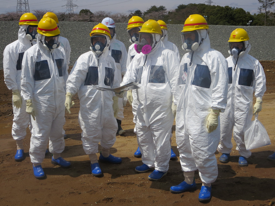 As they inspected an underground storage pool near the crippled Fukushima Daiichi nuclear power plant earlier this month, Tokyo Electric Power Co. President Naomi Hirose (4th from left) and other officials wore protective suits and masks. Radioactive water stored in some of the pits has leaked. Tokyo Electric Power Co./Reuters /Landov As they inspected an underground storage pool near the crippled Fukushima Daiichi nuclear power plant earlier this month, Tokyo Electric Power Co. President Naomi Hirose (4th from left) and other officials wore protective suits and masks. Radioactive water stored in some of the pits has leaked. Tokyo Electric Power Co./Reuters /Landov