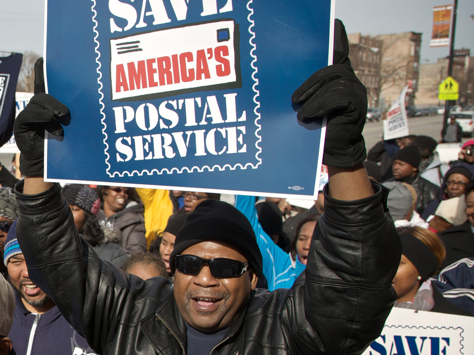 A Chicago postal worker protests in support of Saturday mail delivery in February. John Gress/Getty Images A Chicago postal worker protests in support of Saturday mail delivery in February. John Gress/Getty Images
