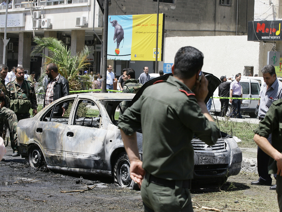 Syrian government security officers after a blast in the Marjeh district of Damascus on Tuesday. Louai Beshara/AFP/Getty Images Syrian government security officers after a blast in the Marjeh district of Damascus on Tuesday. Louai Beshara/AFP/Getty Images