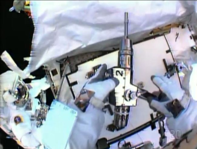 In this image made from video provided by NASA, astronaut Christopher Cassidy, foreground, holds a power wrench as he stows away a coolant pump on the International Space Station on Saturday. Thomas Marshburn is at left. AP In this image made from video provided by NASA, astronaut Christopher Cassidy, foreground, holds a power wrench as he stows away a coolant pump on the International Space Station on Saturday. Thomas Marshburn is at left. AP