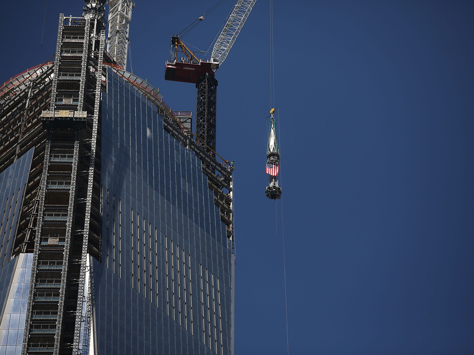 The 408-foot spire was hoisted onto a temporary platform at the top of One World Trade Center on Thursday. Spencer Platt/Getty Images The 408-foot spire was hoisted onto a temporary platform at the top of One World Trade Center on Thursday. Spencer Platt/Getty Images