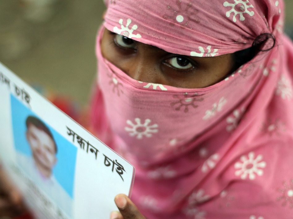A Bangladeshi family member holds up the portrait of her missing relative, believed to be trapped in the rubble of the collapsed Rana Plaza. AFP/Getty Images A Bangladeshi family member holds up the portrait of her missing relative, believed to be trapped in the rubble of the collapsed Rana Plaza. AFP/Getty Images