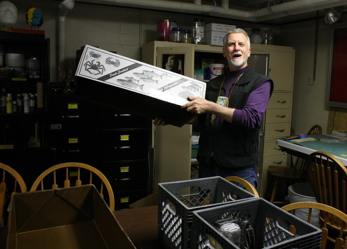 packing up Charlie Bean uses fish boxes to pack up his workspace at the Bill Brady Healing Center. He jokes that people in other states probably don’t use fish boxes like this. (KCAW photo by Ed Ronco)