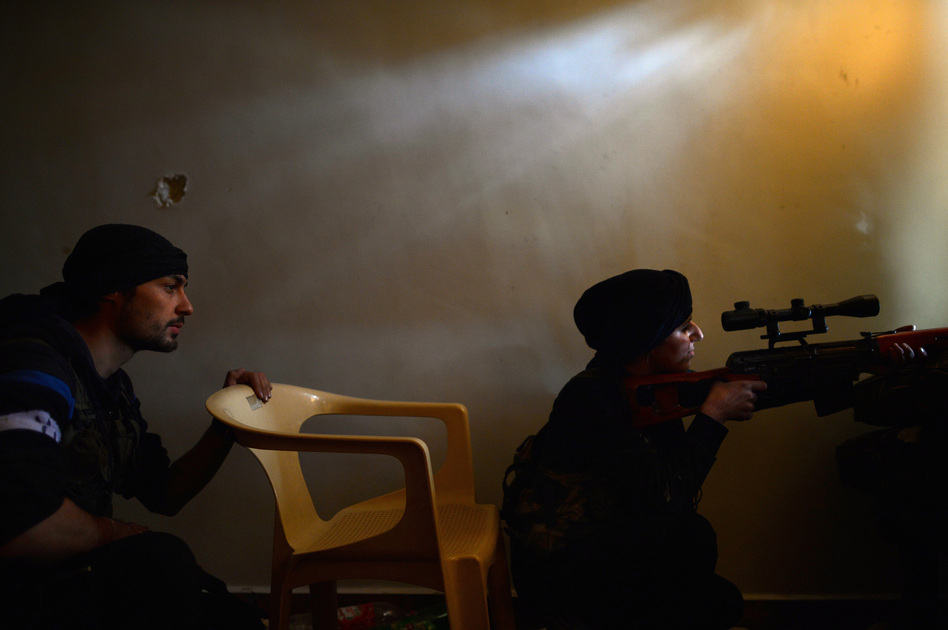 A Syrian female rebel monitors the movement of Syrian government forces in the Sheikh Maqsud district of the northern Syrian city of Aleppo in April. Dimitar Dilkoff /AFP/Getty Images A Syrian female rebel monitors the movement of Syrian government forces in the Sheikh Maqsud district of the northern Syrian city of Aleppo in April. Dimitar Dilkoff /AFP/Getty Images