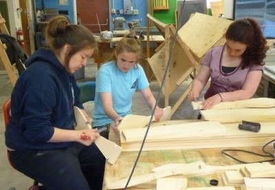 5-31-13 From left, Jasmine Long, Sarah Newlun and Kayla Drumm sand down ceremonial dance paddles during an arts workshp during the Yakutat Tern Festival led by Doug Chilton.