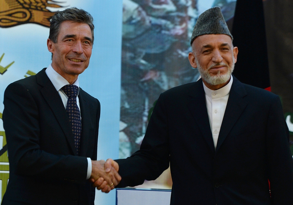 Afghan President Hamid Karzai shakes hands with NATO Secretary-General Anders Fogh Rasmussen after a security handover ceremony at a military academy outside Kabul on Tuesday. Shah Marai/AFP/Getty Images Afghan President Hamid Karzai shakes hands with NATO Secretary-General Anders Fogh Rasmussen after a security handover ceremony at a military academy outside Kabul on Tuesday. Shah Marai/AFP/Getty Images