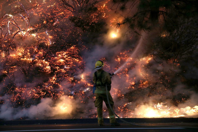 A firefighter uses a hose to douse the flames of the Rim Fire on Saturday near Groveland, California. Justin Sullivan/Getty Images A firefighter uses a hose to douse the flames of the Rim Fire on Saturday near Groveland, California. Justin Sullivan/Getty Images