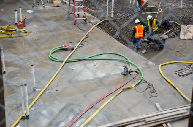 Soboleff Center construction Pumps and hoses are spread throughout the construction site to deal with excess water.